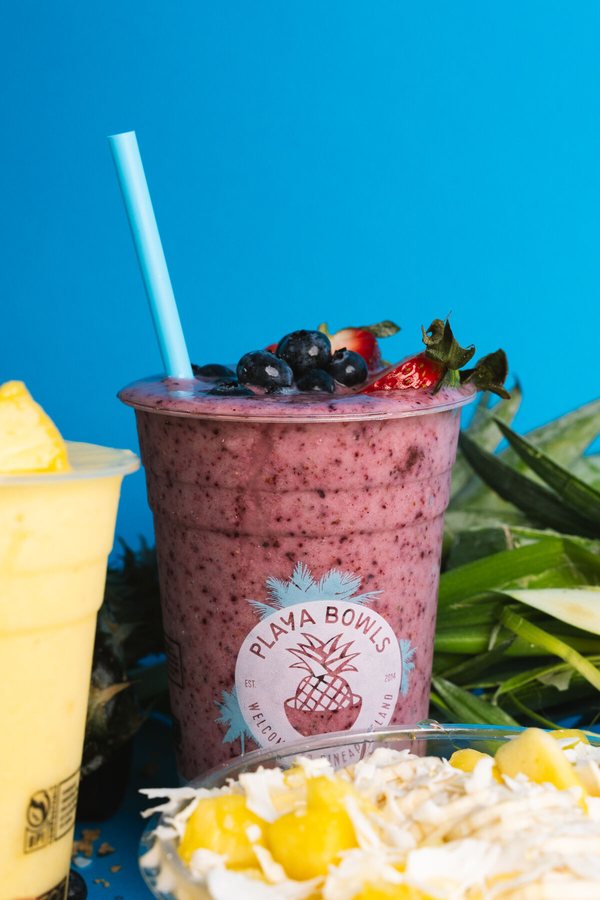 Berry smoothie with blueberries and strawberry against a blue sky, Playa Bowls Atlanta