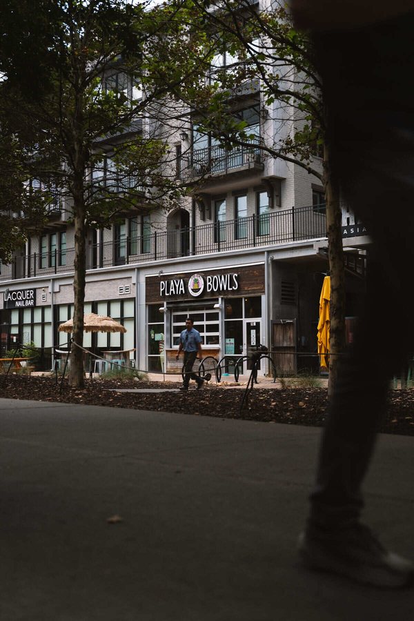 Playa Bowls storefront on the Atlanta Beltline with passing foot traffic